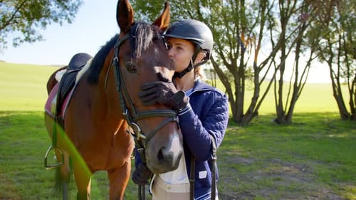 Young Blonde Woman Wearing Helmet Bonding to Her Chestnut Horse While Feeling Tender Multicolored