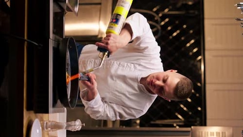 Chef Using Blowtorch to Flambe Food in Pan