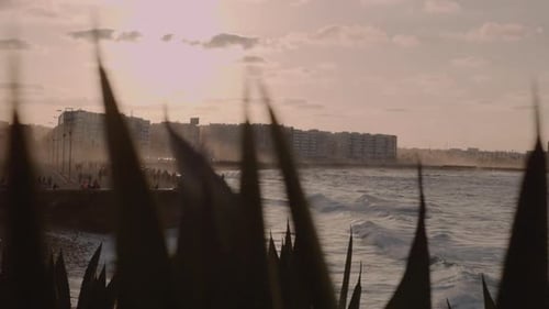 Dynamic tight shot of Casablanca Morocco coast in the Atlantic Ocean, sunset over a partially