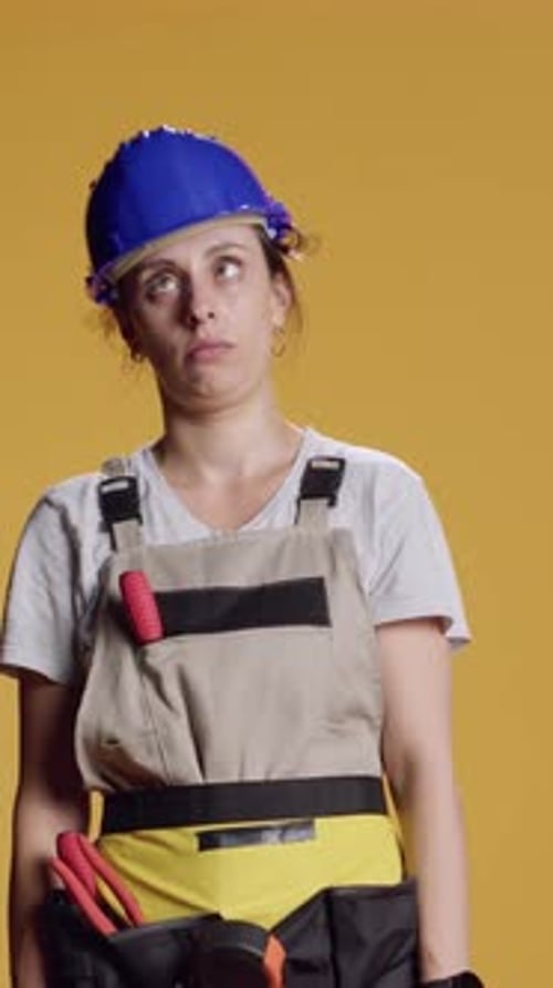 Vertical Video Portrait of Female Builder Being Hit in Head and Feeling Dizzy