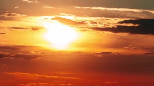 Timelapse Dramatic Sunset with Sun Rays in the Sky Through Orange Layered Clouds