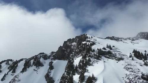 Snowy Mountain Peak. Dramatic clouds, blue sky. British Columbia, Canada.