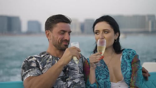 Couple Sipping Champagne on Boat with City View