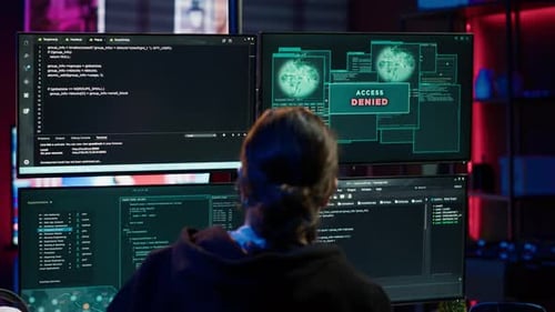 Coder Works at Multiple Computer Screens