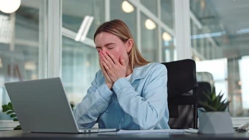 Sleepy Female Yawning During Break at Personal Desktop with Working Equipment
