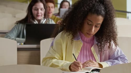 Multiethnic Undergraduates Studying in Lecture Hall