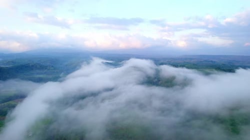 Aerial View of Valley with Clouds and Green Hills