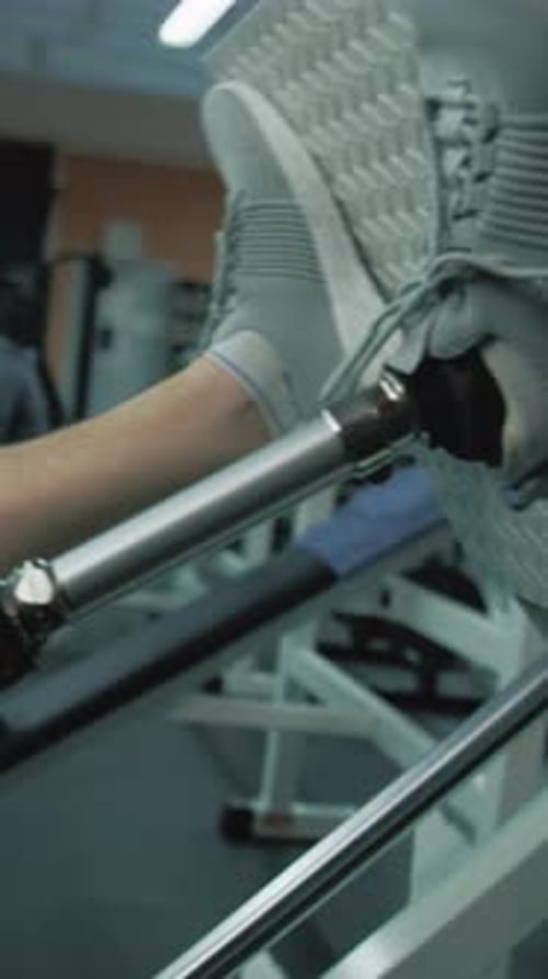 Close Up of Athlete with Prosthetic Leg Exercising on Leg Press Machine