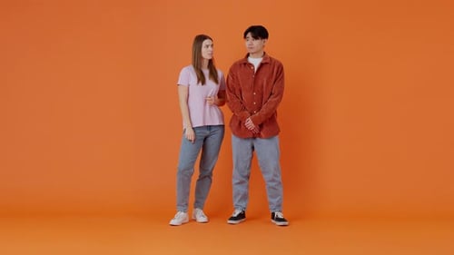 Asian Male and European Female Show Thumbs Down in Premise