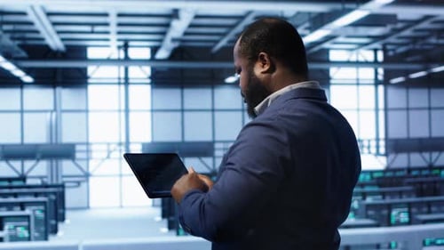 Engineer in Data Center Fixing Errors Affecting Server Rows Rigs