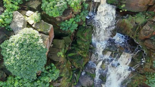 Aerial drone footage of a tall rocky waterfall in the Yorkshire Dales, Pennies. Moorland scene of a