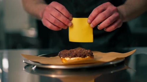 Close Up in Professional Kitchen in a Pizzeria the Chef Assembles a Burger on the Table