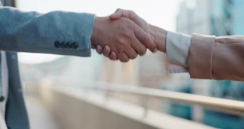 Two People Shaking Hands in a Corporate Setting
