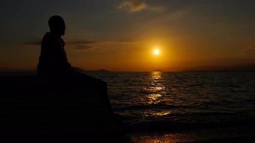 Depressed Man on Pier in Evening