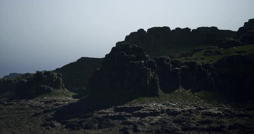 Dramatic Rocky Landscape Under Clear Sky at Dawn with Soft Lighting Effects
