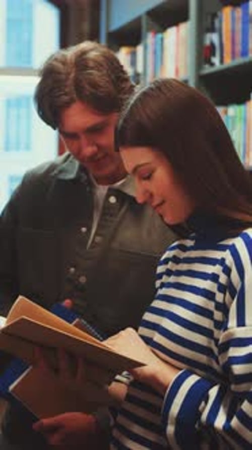 Vertical Screen Students Sharing Book in Library