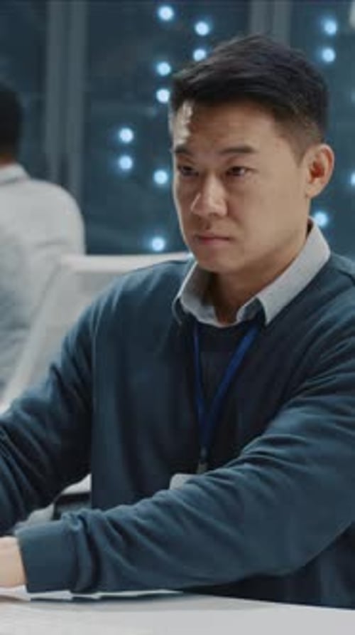 Young Handsome IT Technical Specialist Working in Data Center Digital Computer Office Server Racks