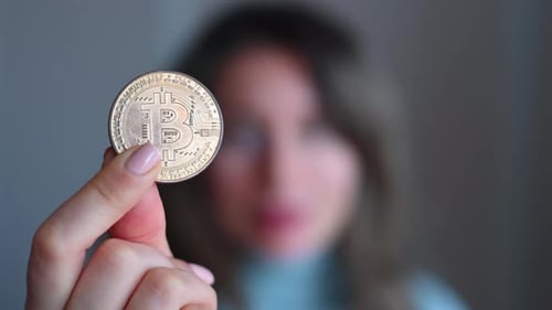 Woman holding a bitcoin crypto currency close up