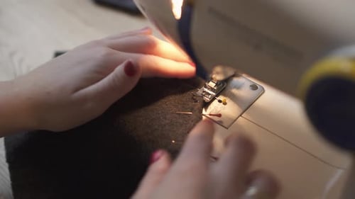 Woman hands using the sewing - close up