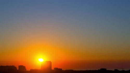 Cloudless Sunrise over a Seaside Town