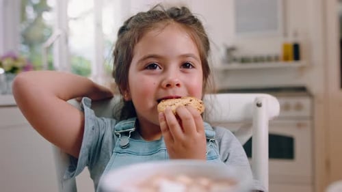 Happy Young Girl Enjoying a Chocolate Chip Cookie