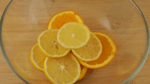 Citrus Slices in Glass Bowl on Wood Surface