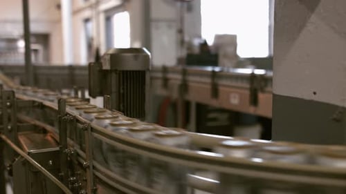 Cans Moving on Conveyor Belt in Factory
