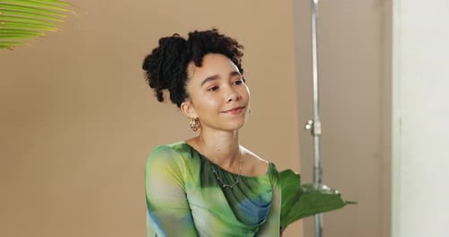 Attractive Woman Smiling in Studio with Tropical Plants