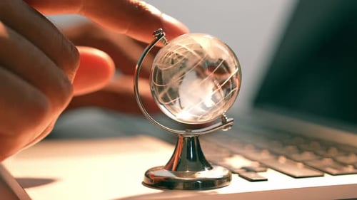 Typing on Laptop with Globe on Computer