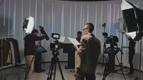 Operator With Storyboard Walking Into Filmmaking Studio