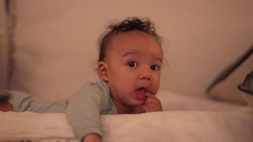 Adorable Baby Lying Down Looking at the Camera