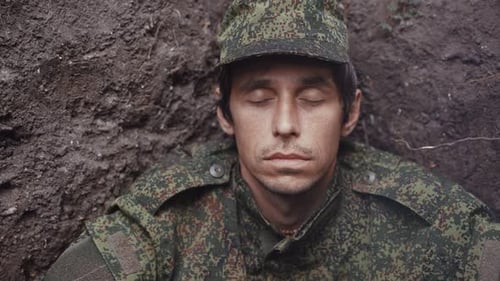 A Tired Thoughtful Soldier in a Trench