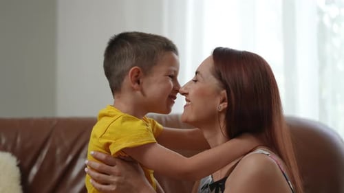Smiling Woman and Child Share Loving Embrace Indoors
