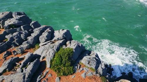 Beautiful Rocky Shoreline Over Deep Stormy Ocean Sunny Day. Drone View Picturesque