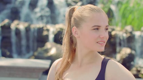 Smiling Girl Portrait. Positive Girl Posing in Sunlight. Happy Girl Portrait Outdoor