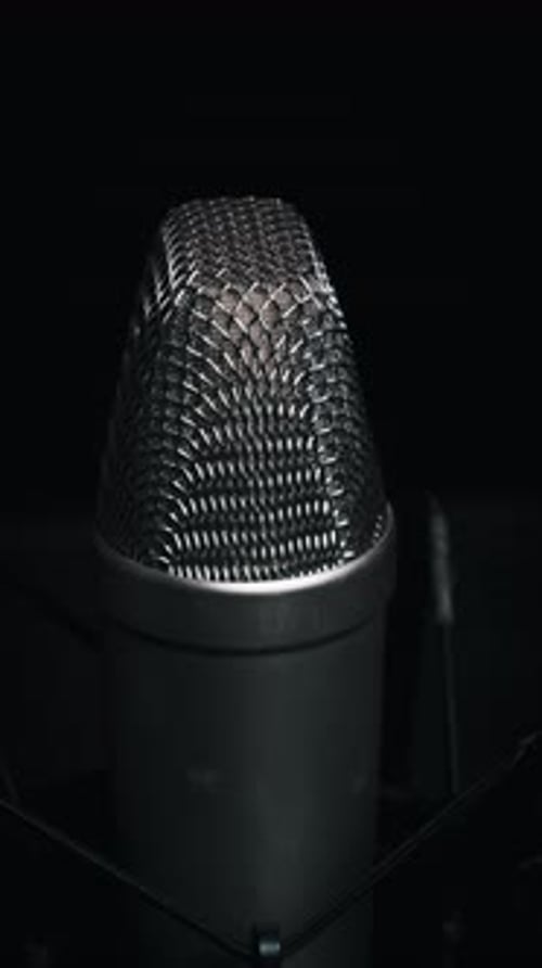 Studio Microphone Rotates on a Black Background CloseUp