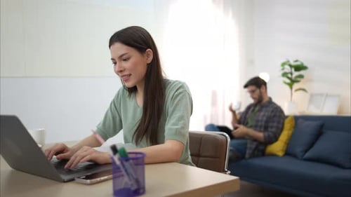 Young Woman Working on Laptop at Home