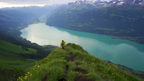 Man Hikes Up Trail On Scenic Swiss Mountain Lake Brienz Emmental Alps man-hikes-up-trail-on-scenic-swiss-mountain-lake-brienz-emmental-alps