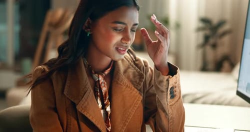 Woman Rubbing Head While Using a Tablet