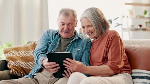 Mature Couple Relaxing and Using a Tablet Device