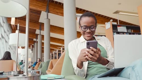 Young Woman Studying in a College Library