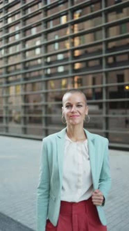 Confident Woman Posing Near Modern Building