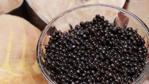 Black Caviar in Glass Pot Closeup Beluga Sturgeon Salted Roe in Glass Bowl Raw Seafood Luxury