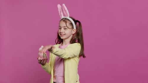 Lovely Little Girl with Bunny Ears Sending Air Kisses in Studio