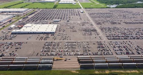 New Cars Parked on Automotive Factory Parking Lot for Worldwide Export Dealer Vehicle Inventory