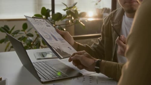 Business People Reviewing Data Charts at Office