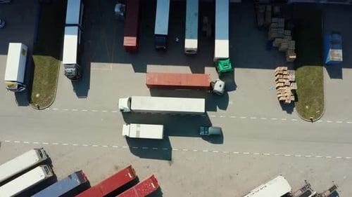Aerial View of a Modern Logistics Center with Various Semitrailer Trucks