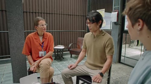 Adults Talking at Table Indoors During Daytime