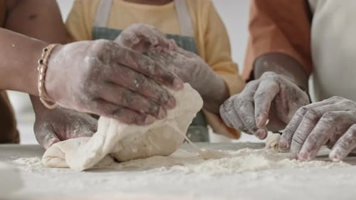 Hands of Family Kneading Dough