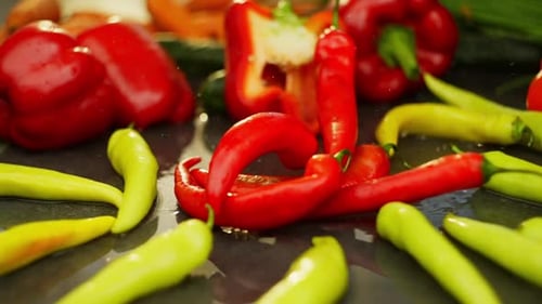 Fresh Peppers Falling onto Table